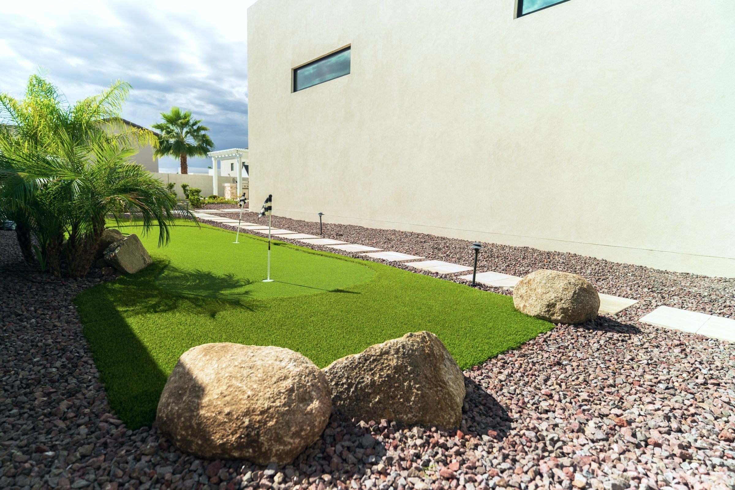 Side-yard putting green with boulders