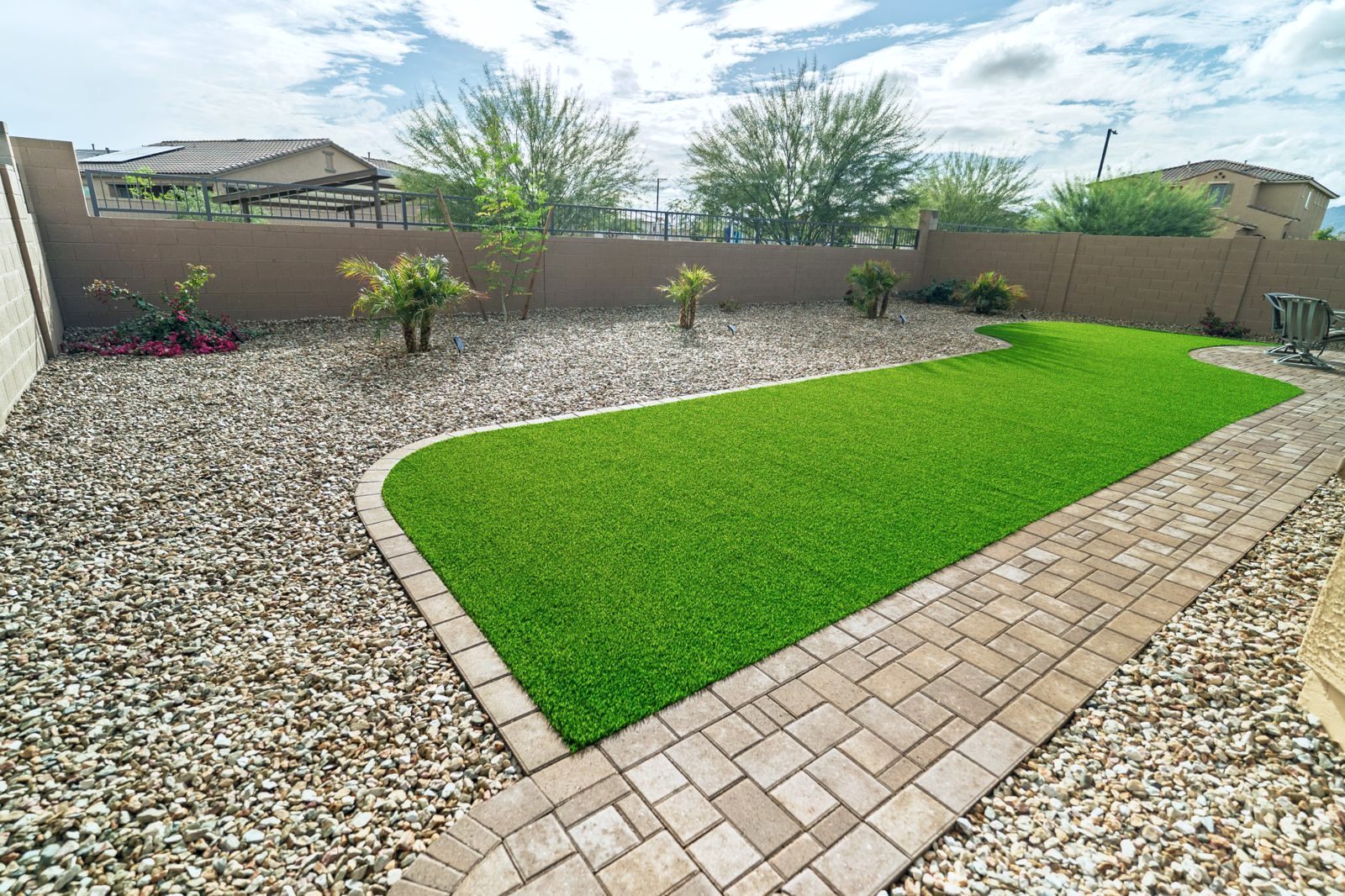 Paver walkway bordering a curved turf lawn