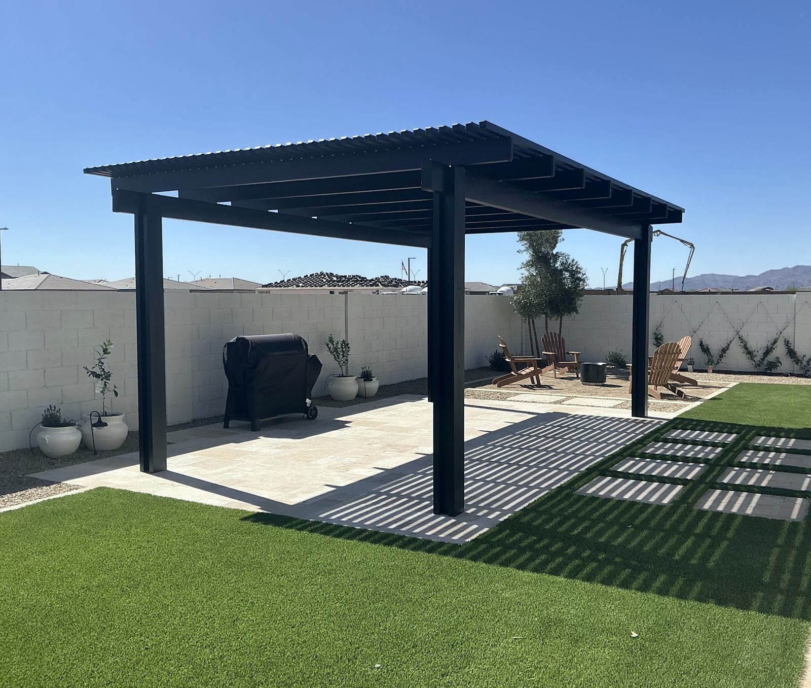 Freestanding lattice pergola over a travertine patio